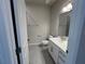 Well-lit bathroom featuring a white vanity, quartz countertop, and a framed mirror at 10012 Zennia Ln, Parrish, FL 34219