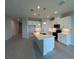 Bright, open kitchen with a center island, quartz countertops, pendant lighting, and stainless appliances at 10012 Zennia Ln, Parrish, FL 34219