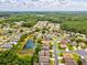 Drone shot of the community, homes, landscaping, and proximity to the pond at 11050 Kiskadee Cir, New Port Richey, FL 34654