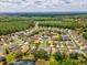 Scenic aerial view of homes within the SummerTree community, surrounded by lush greenery and ponds on a partially cloudy day at 11050 Kiskadee Cir, New Port Richey, FL 34654