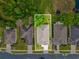 Aerial view of the home's roof and yard highlighting its location relative to nearby ponds and community homes at 11050 Kiskadee Cir, New Port Richey, FL 34654