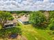 Beautiful backyard featuring a screened-in porch and pond, surrounded by mature trees in the SummerTree community at 11050 Kiskadee Cir, New Port Richey, FL 34654