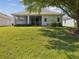 The home has a large backyard with a screened lanai and mature landscaping at 11050 Kiskadee Cir, New Port Richey, FL 34654