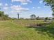 Beautiful backyard overlooking a pond with lush greenery, offering a serene view at 11050 Kiskadee Cir, New Port Richey, FL 34654