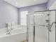 Modern bathroom with glass shower, soaking tub and white tile at 11050 Kiskadee Cir, New Port Richey, FL 34654