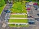An aerial view of the lushly landscaped bocce ball courts with surrounding parking and palm trees at 11050 Kiskadee Cir, New Port Richey, FL 34654