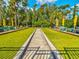Bocce ball courts with benches and yellow umbrellas offer a space for outdoor fun and relaxation at 11050 Kiskadee Cir, New Port Richey, FL 34654