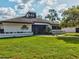 Exterior of the community clubhouse with lush green lawn and well-maintained landscaping at 11050 Kiskadee Cir, New Port Richey, FL 34654