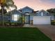 Charming blue single-story home featuring a well-manicured lawn and a two-car garage at 11050 Kiskadee Cir, New Port Richey, FL 34654