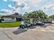 Several golf carts lined up in front of the community clubhouse on a sunny day at 11050 Kiskadee Cir, New Port Richey, FL 34654