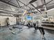 A view of the community gym featuring weights, stationary bikes, and a television at 11050 Kiskadee Cir, New Port Richey, FL 34654