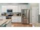 Kitchen featuring stainless steel appliances, granite countertops, and white cabinetry at 11050 Kiskadee Cir, New Port Richey, FL 34654
