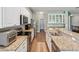 Bright kitchen with white cabinetry, stainless steel appliances and granite countertops at 11050 Kiskadee Cir, New Port Richey, FL 34654