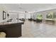 Bright lounge features large windows, comfortable seating, and a welcoming atmosphere for residents at 11050 Kiskadee Cir, New Port Richey, FL 34654