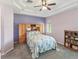 Spacious bedroom with tray ceiling, large window, and carpet flooring at 11050 Kiskadee Cir, New Port Richey, FL 34654
