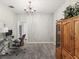 Spacious office featuring neutral colored walls, chandelier, and large built in cabinet at 11050 Kiskadee Cir, New Port Richey, FL 34654