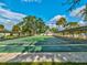 A view of outdoor shuffleboard courts, benches, and manicured landscaping at this community at 11050 Kiskadee Cir, New Port Richey, FL 34654