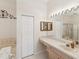 Bathroom boasting a large mirror and vanity, complemented by a separate bath and shower at 11524 Holly Ann Dr, New Port Richey, FL 34654