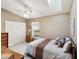 Cozy bedroom with a bright skylight, comfortable bed, and closet space at 11524 Holly Ann Dr, New Port Richey, FL 34654