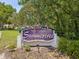 The Villas at Summertree community sign adorned with patriotic flags and lush greenery at 11524 Holly Ann Dr, New Port Richey, FL 34654