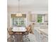 Bright dining area with a window seat, pendant lighting, and view of backyard at 11524 Holly Ann Dr, New Port Richey, FL 34654