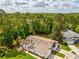 Aerial view of a single Gathering home with a long driveway and beautiful trees in the background at 11524 Holly Ann Dr, New Port Richey, FL 34654