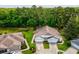 A long driveway leads to a charming home with two garage doors and manicured landscaping at 11524 Holly Ann Dr, New Port Richey, FL 34654