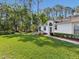 Lush front yard and a well-manicured lawn and landscaping leading to the home's entrance at 11524 Holly Ann Dr, New Port Richey, FL 34654