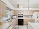 Bright kitchen with ample cabinet space, modern appliances, and a breakfast bar at 11524 Holly Ann Dr, New Port Richey, FL 34654