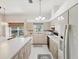 Spacious kitchen with light-colored cabinets, modern appliances, and a view to the backyard at 11524 Holly Ann Dr, New Port Richey, FL 34654
