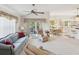 Bright living room with large windows, ceiling fan, comfortable seating, and access to outdoor patio at 11524 Holly Ann Dr, New Port Richey, FL 34654