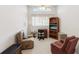 Relaxing living room with comfortable seating, desk, and natural light at 11524 Holly Ann Dr, New Port Richey, FL 34654