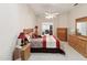 Bright main bedroom featuring a ceiling fan, carpet flooring, and traditional furnishings at 11524 Holly Ann Dr, New Port Richey, FL 34654