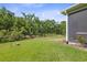 Expansive backyard backing onto a lush green space for added privacy at 12214 Grizzly Ln, New Port Richey, FL 34654