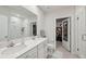 Bright bathroom features double sinks, shower, and walk-in closet at 12214 Grizzly Ln, New Port Richey, FL 34654