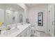 Modern bathroom with double sinks, a large mirror, and a glass-enclosed shower at 12214 Grizzly Ln, New Port Richey, FL 34654