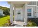 Covered entryway with a charming door, wreath, and decorative features at 12214 Grizzly Ln, New Port Richey, FL 34654