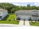 Charming townhomes with well-manicured lawns, garages, and inviting front porches at 12214 Grizzly Ln, New Port Richey, FL 34654