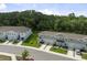 Exterior of modern townhomes featuring manicured lawns and attached garages at 12214 Grizzly Ln, New Port Richey, FL 34654
