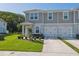 Attractive townhome with a one-car garage, manicured lawn, and fresh landscaping at 12214 Grizzly Ln, New Port Richey, FL 34654