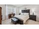 Comfortable bedroom with a decorative headboard, side tables and stylish window treatment at 12214 Grizzly Ln, New Port Richey, FL 34654
