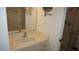 Well-lit bathroom featuring a sink, vanity with storage, and a walk-in shower at 12371 Dearborn Dr, Hudson, FL 34667