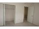 Bright bedroom with closet access, carpeted floors, and neutral walls at 12371 Dearborn Dr, Hudson, FL 34667