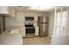 Well-lit kitchen with stainless steel appliances, white cabinets, and neutral countertops at 12371 Dearborn Dr, Hudson, FL 34667