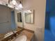 Bathroom vanity featuring granite countertop and decorative mirror at 12541 Dearborn Dr # B, Hudson, FL 34667