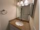 Bathroom with granite countertop and decorative mirror and lighting at 12541 Dearborn Dr # B, Hudson, FL 34667