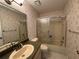 Well-lit bathroom featuring a shower/tub combo with sliding glass doors and floral wallpaper at 12541 Dearborn Dr # B, Hudson, FL 34667
