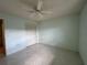 Cozy bedroom featuring tiled floor, ceiling fan, and closet space at 12541 Dearborn Dr # B, Hudson, FL 34667