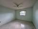 Cozy bedroom with tiled floor, ceiling fan and window allowing plenty of natural light at 12541 Dearborn Dr # B, Hudson, FL 34667
