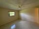 Bedroom with tile flooring and view out window at 12541 Dearborn Dr # B, Hudson, FL 34667